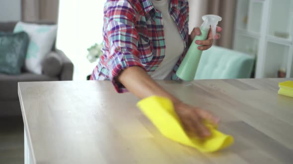 Mature Woman Household Is Wiping Table with Microfiber Cloth at Home Room