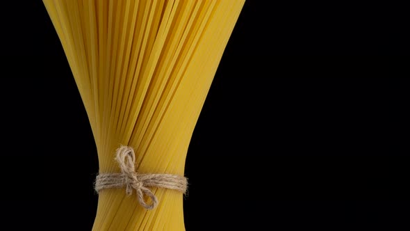 Italian spaghetti pasta on black background, rotate. Vegan, vegetarian food. 4K UHD video