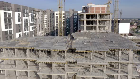 Building crane and monolituc building under construction. Construction site