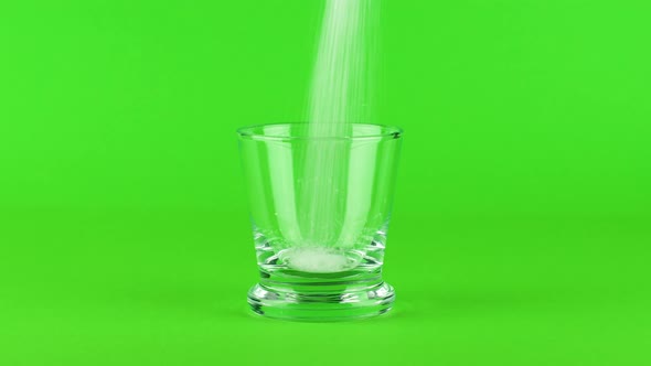 Pour Sugar Shot Glass Thick Bottom Green Contrasting Background. Concept