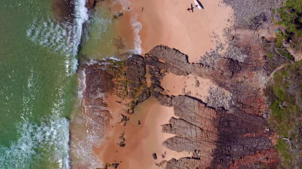 Surfers At The Sunny With Splashing Sea Waves Beach Of Noosa National Park In QLD, Australia. Aerial