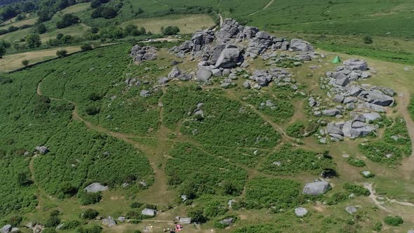 Wide shot aerial tracking forward over Bonehill Rocks, Dartmoor, Devon, England.