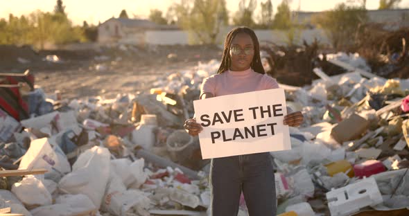 African American Woman Holding Save the Planet Sign