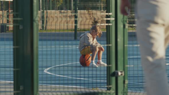 Boy waiting for dad on the court