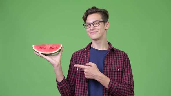 Young Handsome Teenage Nerd Boy with Slice of Watermelon