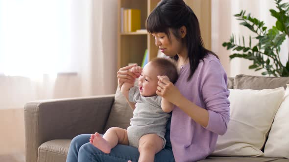 Happy Young Mother with Little Baby Boy at Home 