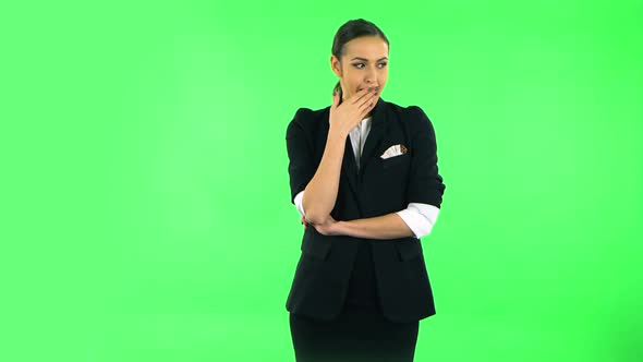 Girl Listens Carefully To Boring Information and Looks Around. Green Screen