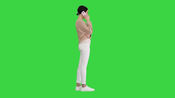 Emotional Smiling Young Woman Talking on the Phone and Gesturing on a Green Screen, Chroma Key