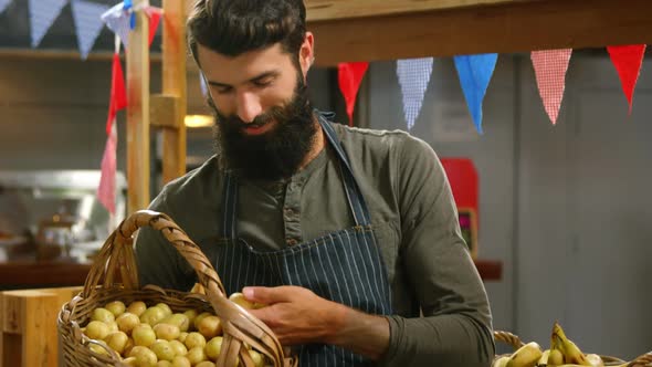 Male staff holding a basket of lime