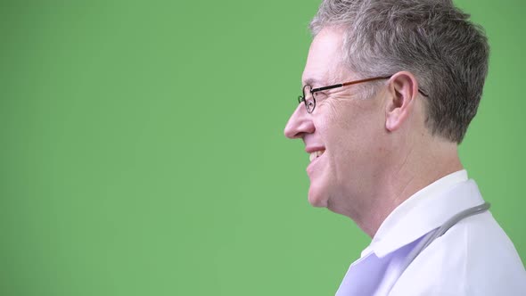 Profile View of Happy Mature Man Doctor Wearing Eyeglasses