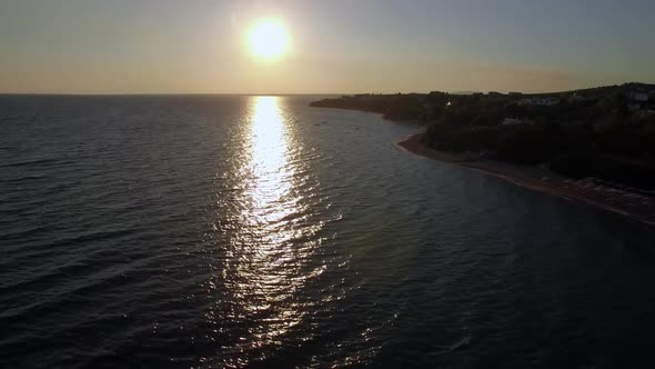  - Aerial View of Shoreline and Sea with Boats at Sunset