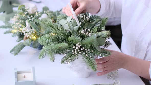 Woman Decorated a Christmas Table Decoration