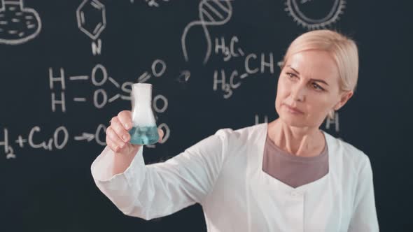 Chemistry Teacher Holding Up Steaming Flask