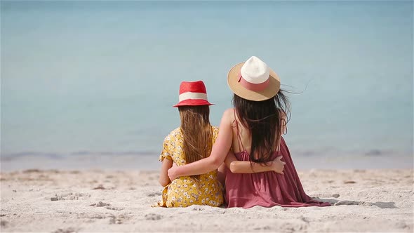 Beautiful Mother and Daughter at Beach Enjoying Summer Vacation.