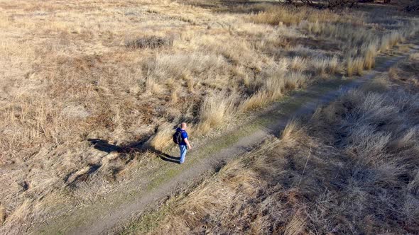 Mature man hiking is lost and can't get a cell mobile phone signal - aerial orbit view