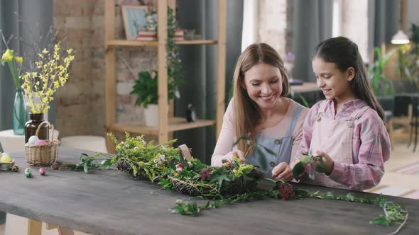 Happy Woman and Girl Making Flower Arrangement