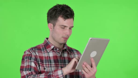 Portrait of Young Man Using Digital Tablet Green Chroma Screen