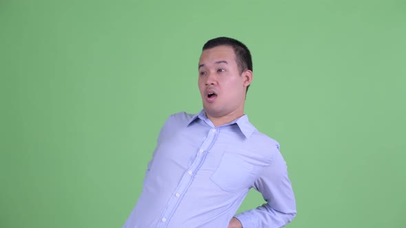 Stressed Asian Businessman Having Back Pain