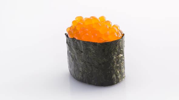Spinning Nori Sushi with Red Caviar Isolated on the White Background.
