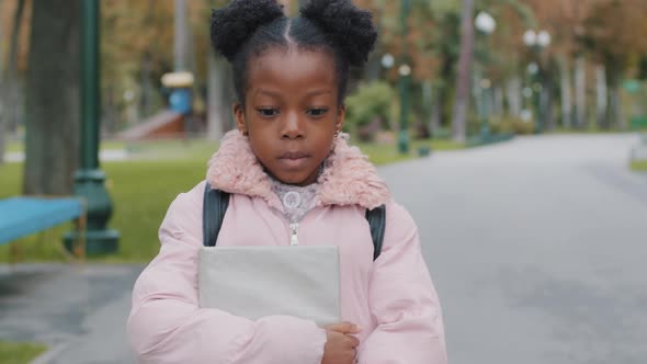 Closeup Portrait Outdoors Serious Sad Little Cute African American Schoolgirl Holding Notebook