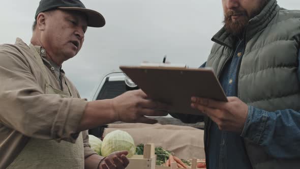 Man Buying Vegetables At Farmers