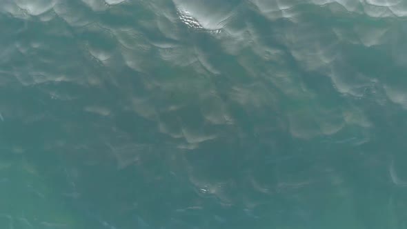 Top-down View of the Sea Waves. The Camera Is Very Low Above the Water. Sea Ripples. Aerial View