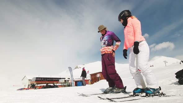 Hipster Caucasian Ski Intsructors Teach Female Beginner Skier To Ski