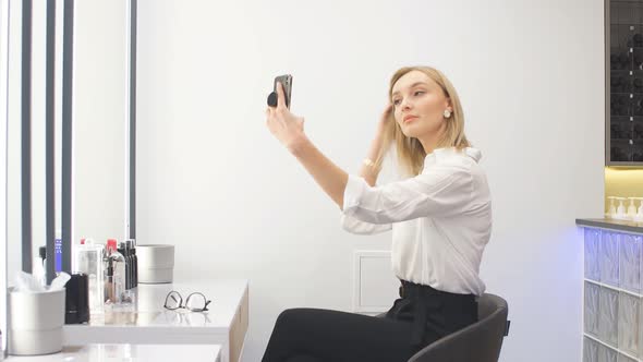 Attractive Girl Make-up Artist Takes a Selfie at Her Workplace