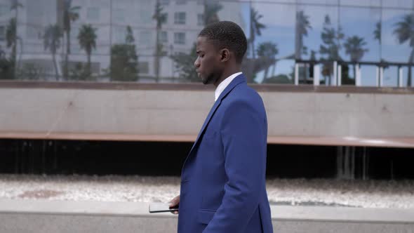 Businessman using smartphone in city