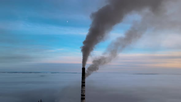 Coal Power Plant High Pipes with Black Smoke Moving Upwards Polluting Atmosphere
