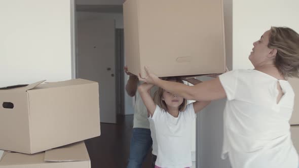 Family Couple and Two Girls Moving Into Apartment