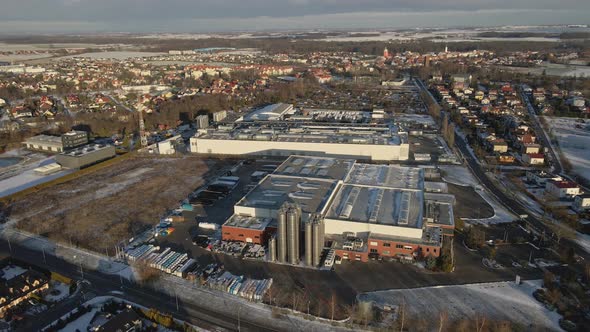 Modern Industrial Factory Near Residential Area in European City Aerial View