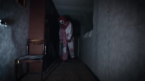 Creepy and Evil Clown in a Gloomy and Abandoned Room