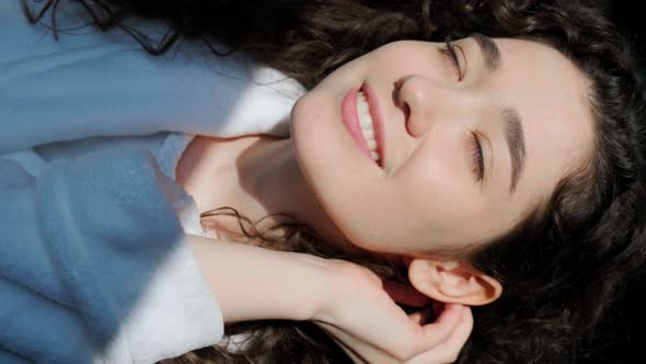 Curly Haired Girl Looking at Camera with Charming Smile Play with Sun Rais