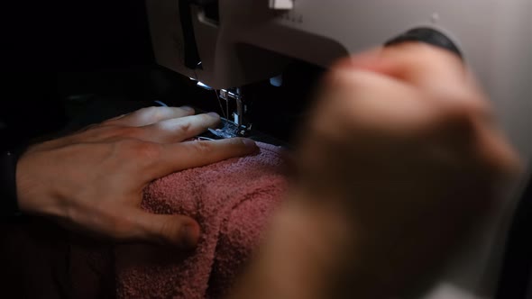 Sewing Machine. sewing machine needle rapidly moves up and down. The tailor sews towel. The process 