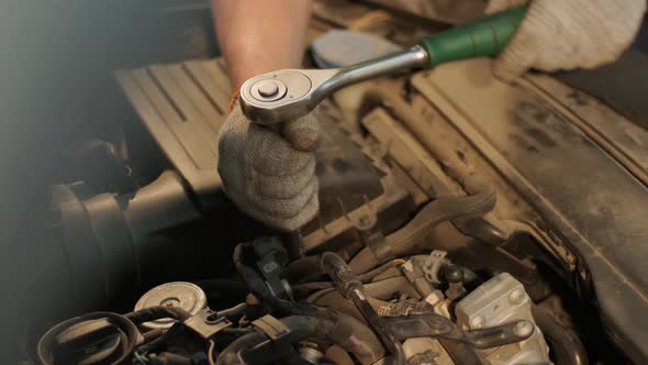 Auto mechanic repairing car engine