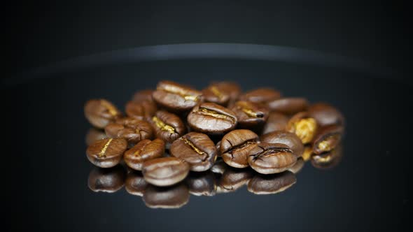 Dark Coffee Beans With Reflection On Surface. - rotating shot