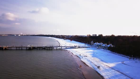 Gdansk Brzezno pier in winter, aerial shot. Flying low, slowly towards the pier. Sunny winter day. G