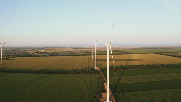 Aerial Footage of Wind Turbines in Field During Sunset