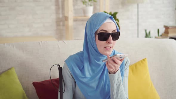 Portrait of a Blind Muslim Girl at Homeuse a Smartphone