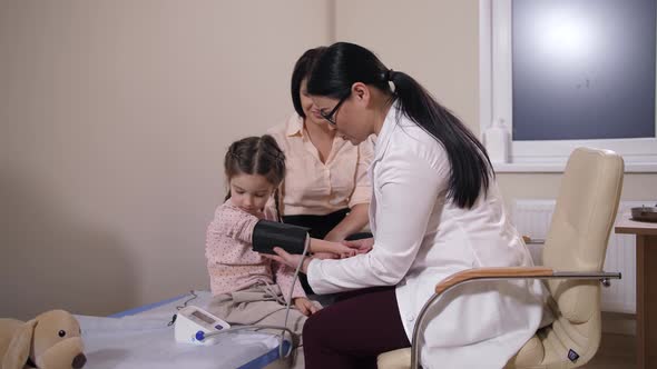 Family Doctor Measuring Pressure of Child Patient