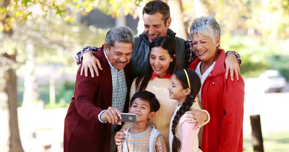 Multi-generation family taking a selfie in the park