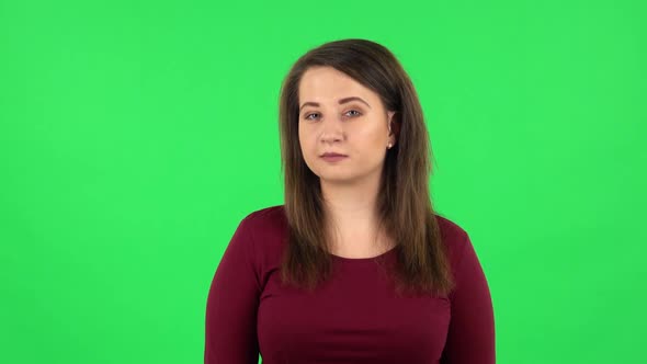 Portrait of Pretty Girl Coquettishly Smiling While Looking at Camera. Green Screen