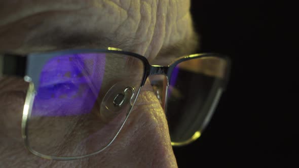 Closeup of the Focused Eyes of a Businessman Wearing Computer Glasses