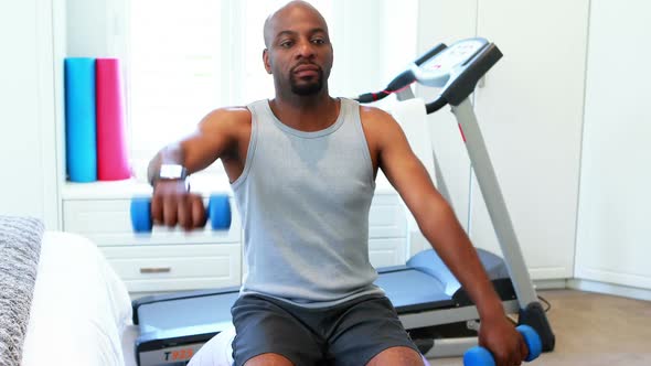 Man exercising with dumbbells 4k