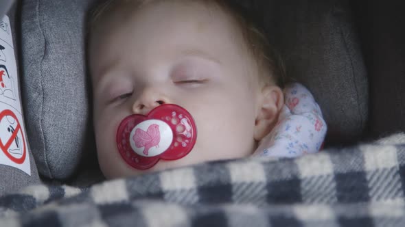 Baby boy sleeping in pram