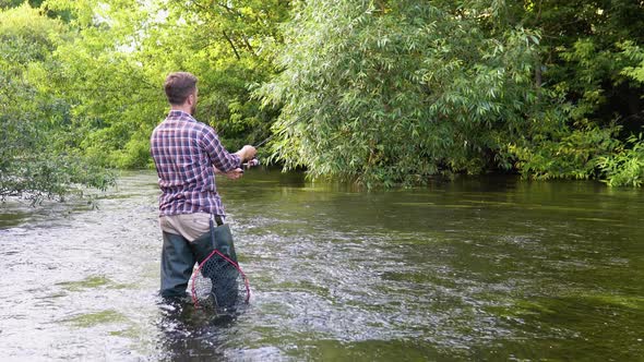 Fisherman with Fishing Rod on the River