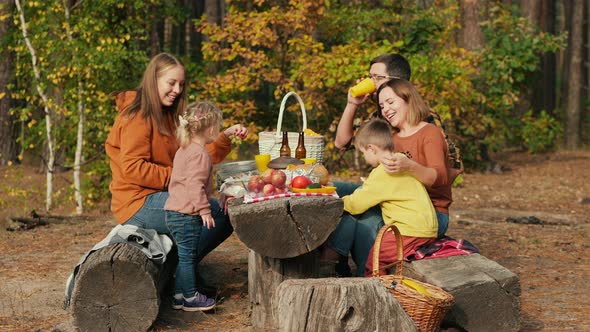 Family on a Picnic at a Resting Place in a Pine Forest