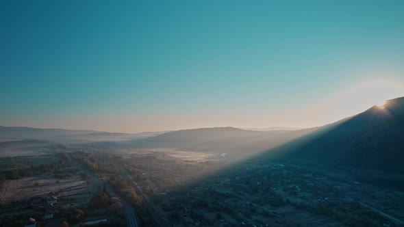 Aerial Drone View of Sunrise Over Misty Mountain Walley with River