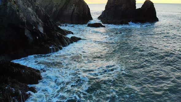 Rock formation in sea at dusk 